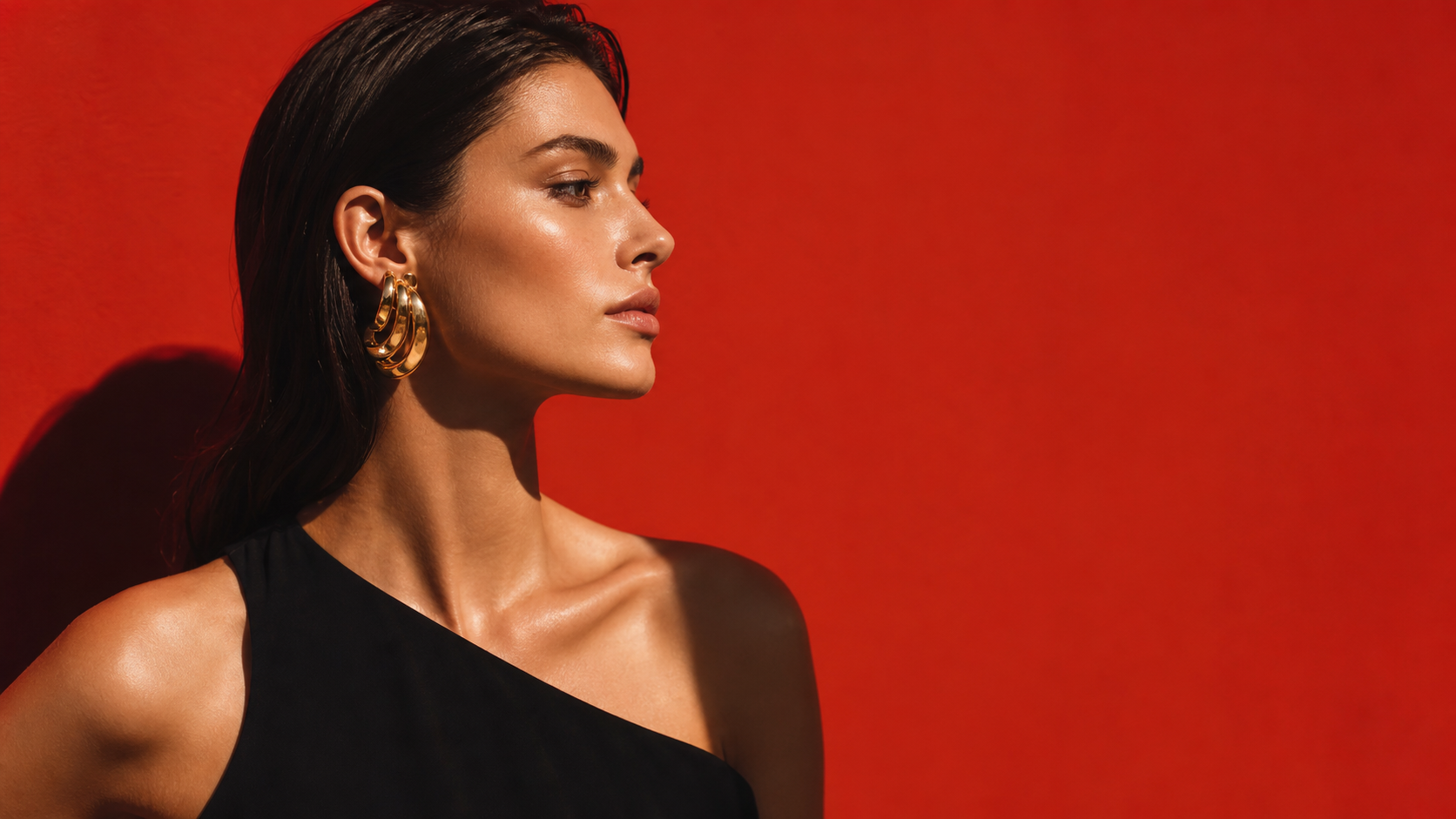 AUWE editorial model wearing gold statement earrings